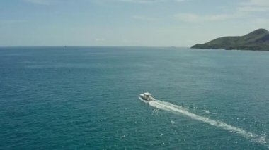 Aerial view of a fast motor spoon sailing between islands in the Indian Ocean. Luxury vacation on a yacht. High quality 4k footage