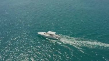 Aerial view The boat is sailing on the ocean. A fast boat sails on the waves in the sea with blue water. High quality 4k footage