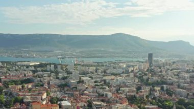 Aerial view Split Croatia. Seaside town in the mountains, houses with red roofs, port, streets and roads in the old town. High quality 4k footage