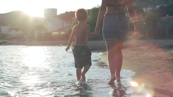 Mom Holds Her Sons Hand Walk Seashore Feet Water Happy — Video