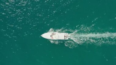 Aerial view of a speed boat sailing on the Indian Ocean. The shot is parallel to the water and the yacht is sailing across the sea. High quality 4k footage