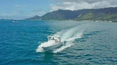 Aerial view of a motor boat sailing on blue ocean water. Speed motor luxury yacht in the sea. High quality 4k footage