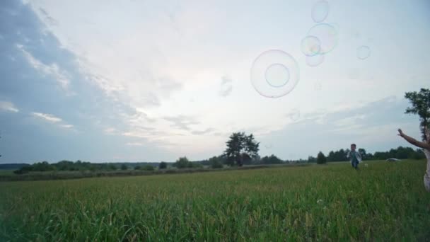 Slow Motion Video Children Running Soap Bubbles Popping Them Happy — Wideo stockowe