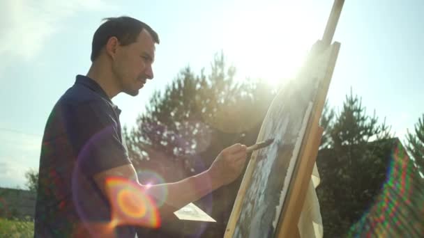 Male Artist Paints Picture Easel Brush Sunlight Inspiration Beautiful Landscape — Stok video