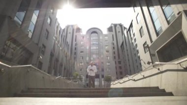 The manager in casual clothes is leaving the office and texting on the phone. Serious facial expression and solving business cases by a person. High quality 4k footage