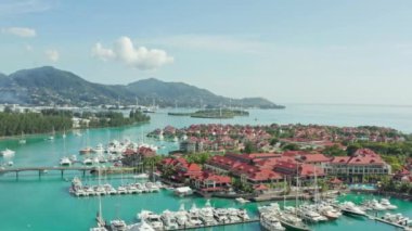 Aerial view Victoria Seychelles. Yacht parking near a luxury resort on an island in the Indian Ocean. Beautiful landscape of mountains with beaches near the ocean. High quality 4k footage