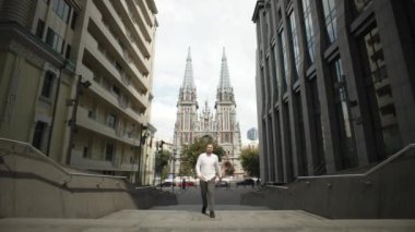 A businessman goes to work in an office in a business center. A serious man dressed in casual clothes goes to work in the downtown of the city. High quality 4k footage