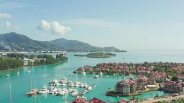 Aerial view marina on the island of Mahe, Seychelles. Beautiful landscape of exotic resorts. Yachts and boats are moored on the shores of the Indian Ocean. High quality 4k footage