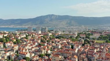 Hava görüntüsü Hırvatistan 'ı böldü. Adriyatik Denizi kıyısındaki dağların arka planına karşı kırmızı çatıları olan eski evleri olan tarihi şehir merkezi. Yüksek kalite 4k görüntü