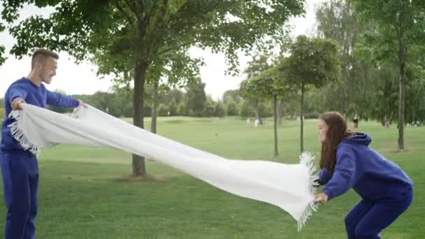 Ouders Spreiden Een Deken Het Gras Kinderen Rennen Naar Hen — Stockvideo