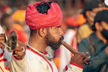 Jaipur, Rajasthan, India- April 05, 2022: man playing alghoz clipart