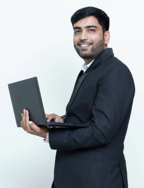 Male model looking at camera with laptop in hand.