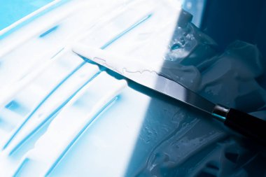 Mavi arka planda beyaz kozmetik kremi çapraz vuruşları. Yüz kremi, vücut losyonu, nemlendirici leke. Güzellik ürünü dokusu