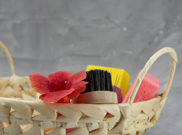 Gift basket with cosmetics on a light concrete background