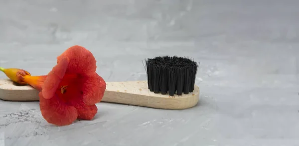 Brush for dry anti-cellulite massage or cleansing on a gray background. Beauty concept.
