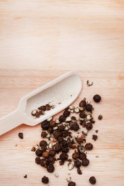 Tahta yüzeyde siyah karabiber.