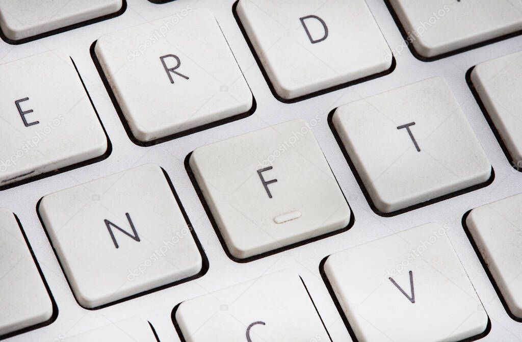 Non-fungible token or NFT concept, NFT spelled out on computer keyboard