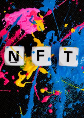 NFT in letter dice with paint splatters in multiple colors clipart