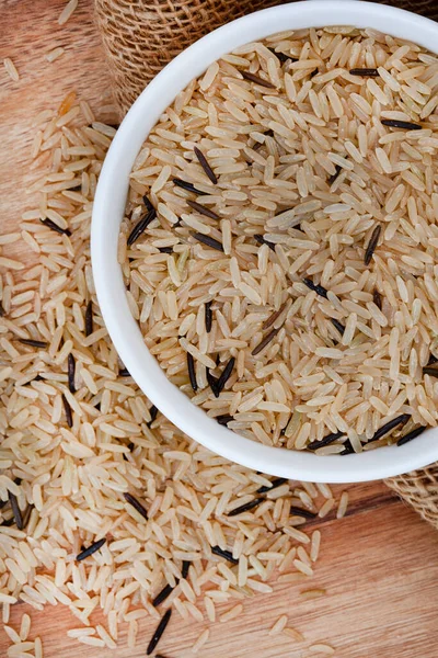 mixture of wild rice and brown rice on a rustic table surface