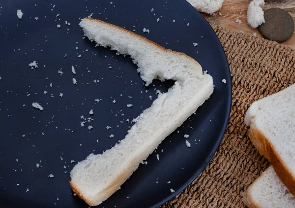 Crusts and crumbs of white bread slices as food security and shortages loom