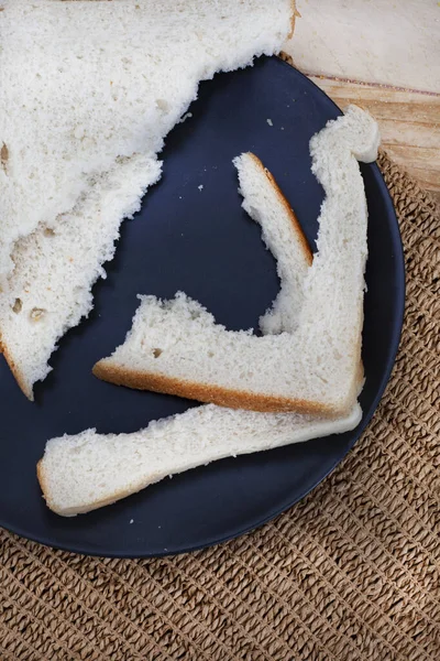 Crusts and crumbs of white bread slices as food security and shortages loom