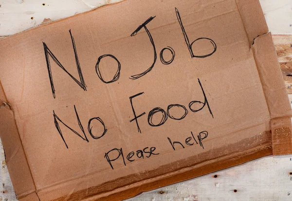 cardboard sign from someone begging for food