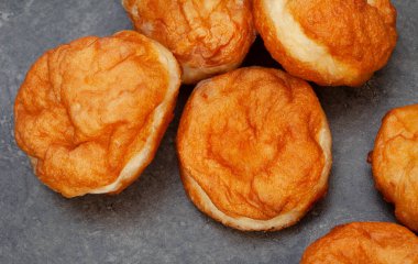 Güney Afrika vetkoek, bol yağda kızartılmış tuzlu hamur, benekli gri arka planda fotokopi alanı ile