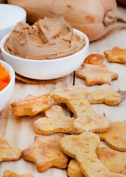 homemade organic dog biscuit treats and ingredients on raw wood with copy space