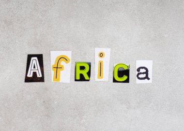 Africa, written with lettering from magazine clippings on mottled grey