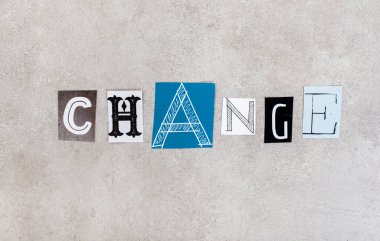 Change, written with lettering from magazine clippings on mottled grey