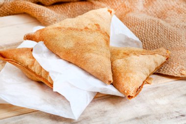 South African chicken Samosas on rustic table