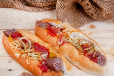 South African famous boerewors roll, juicy and topped with onions on a rustic surface
