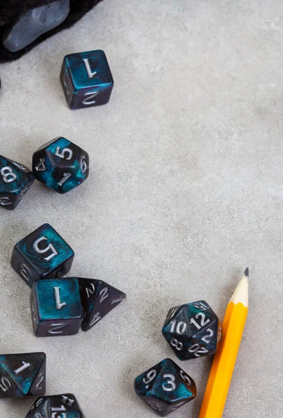 Dungeons and Dragons, a game of dice and imagination. Dice on grey with copy space