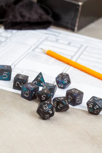 Dungeons and Dragons, a game of dice and imagination. Dice on grey with copy space