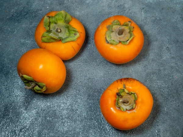 Four Persimmons Black Background Persimmon Varieties Chamomile Still Life Big — Stock Photo, Image