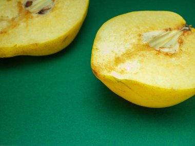 Sliced quince.Juicy fruit on a yellow background. Ripe useful product.Weathered fruit pulp. Nutrition on a diet.