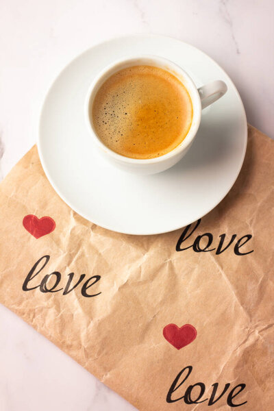 cup of black coffee on paper with the inscription love close u