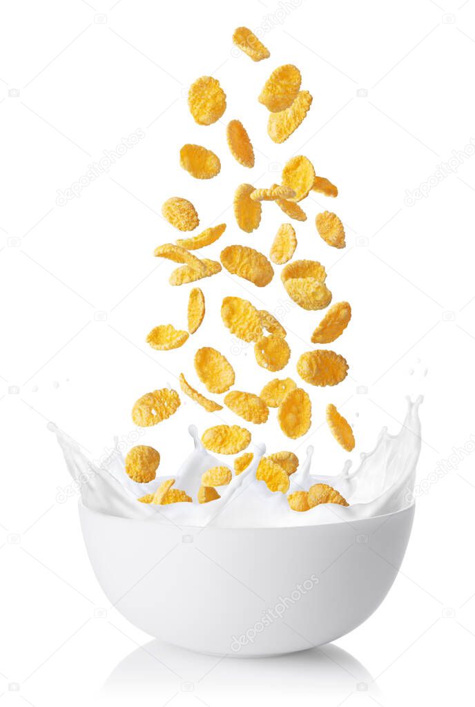 cornflakes falling into bowl with milk splashes isolated on white