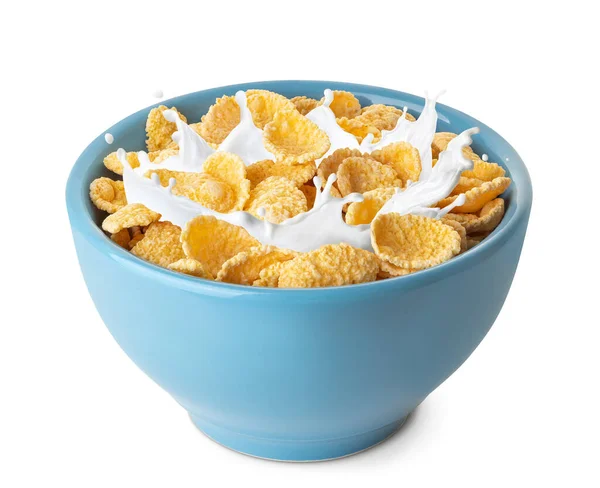 Cornflakes met spetterende melk in blauwe kom — Stockfoto