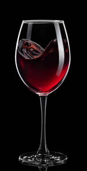Брызги от красного вина в стакане, изолированные на черном — стоковое фото