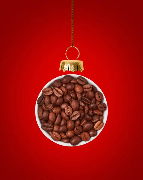 Christmas ball is made from coffee beans on red background. — Stock Photo, Image