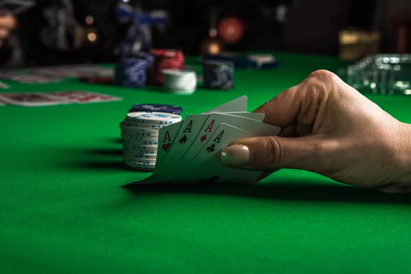 Aces in poker player hand and stack of chips. Concept leisure activity.