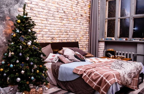 Een Groot Tweepersoonsbed Een Kerstboom Staan Tegen Een Stenen Muur — Stockfoto