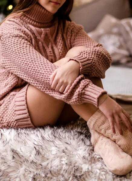 Μια Νεαρή Γυναίκα Ένα Ροζ Πλεκτό Πουλόβερ Και Κάλτσες Κάθεται — Φωτογραφία Αρχείου