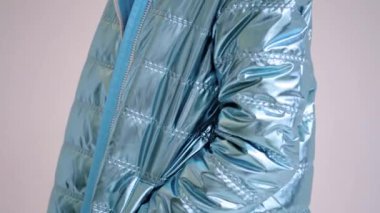 Nice coat in blue metallic color with pockets and white zipper