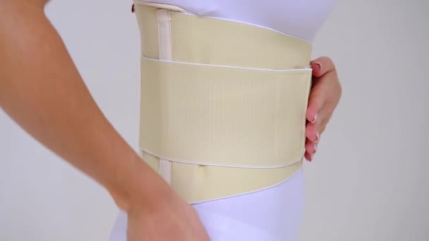 Woman Wearing Beige Support Belt Isolated Whitethe Girl Stands Sideways — Videoclip de stoc