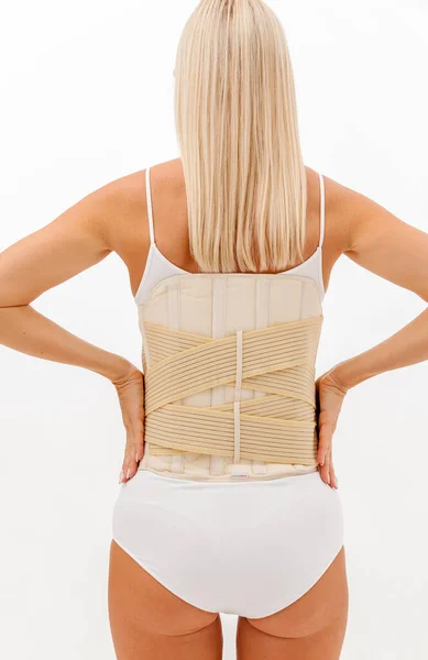 Orthopedic lumbar corset on the human body. Back brace, waist support belt for back. Posture Corrector For Back Clavicle Spine. Post-operative Hernia Pregnant and Postnatal Lumbar brace after surgery.