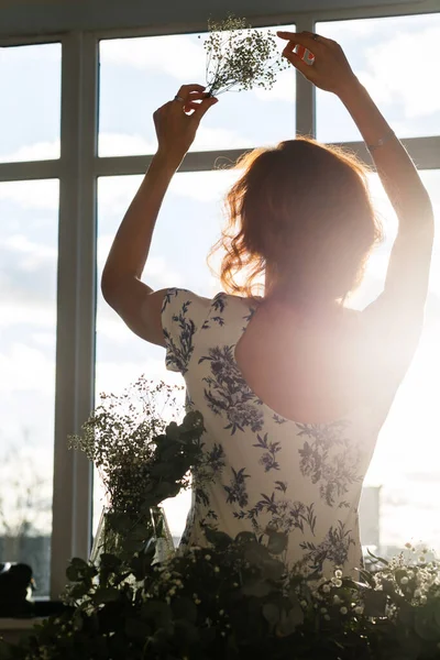 Dziewczyna Siedzi Przed Oknem Bukietem Kwiatów Podniesionych Rękach Oknem Jest — Zdjęcie stockowe