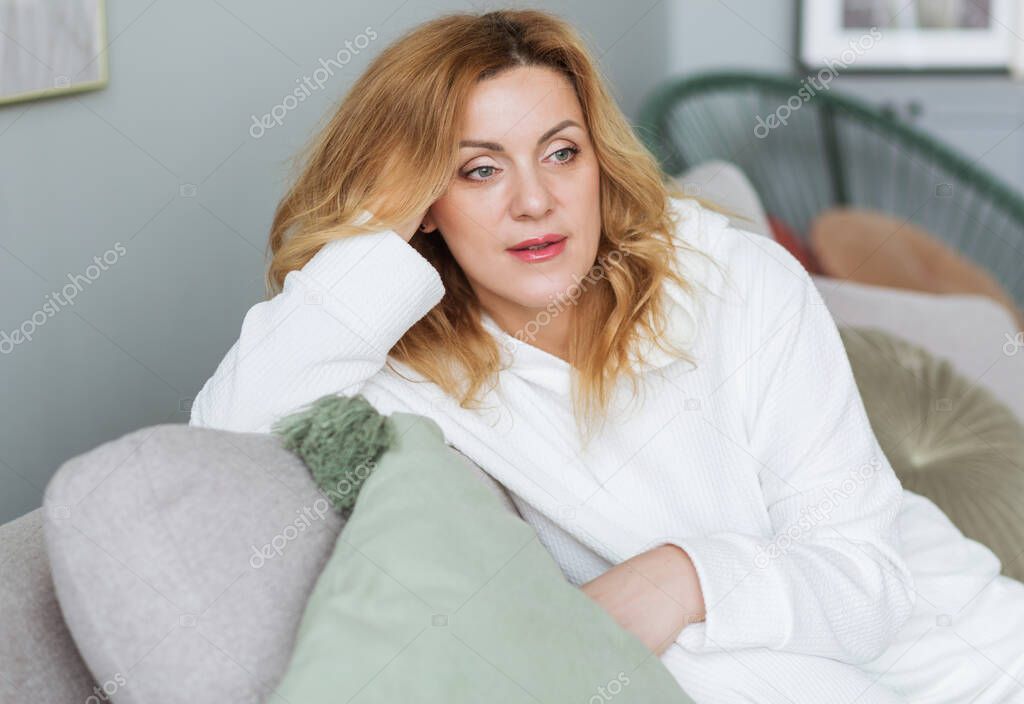 calm woman with closed eyes resting on cozy couch, enjoying lazy leisure time, attractive peaceful young female relaxing, daydreaming. Photo
