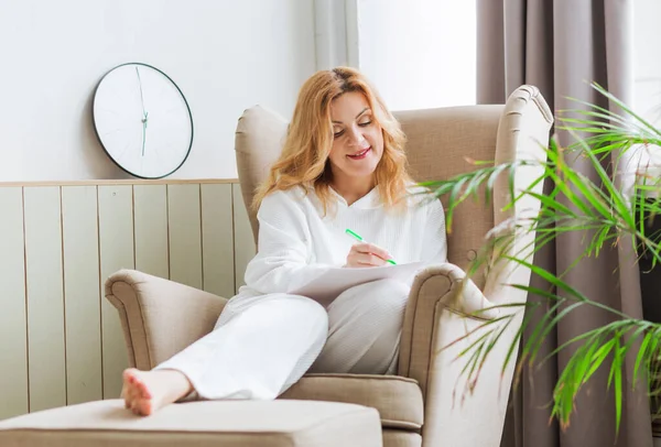 Woman White Clothes Sits Home Chair Writes Her Dreams Paper — Stock Photo, Image